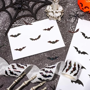 Close-up of glitter and matte black bat stickers for Halloween gift wrapping