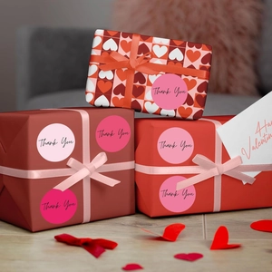 Pink heart-themed Thank You stickers used for sealing decorative gift boxes elegantly
