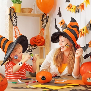 Close-up of Halloween cartoon stickers applied on face, arms, and festive pumpkins