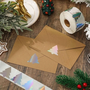Holographic Christmas tree sticker on kraft envelope with festive holiday decorations