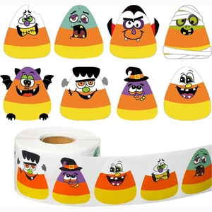 Roll of 500 Halloween candy corn stickers featuring ghost and mummy monster designs