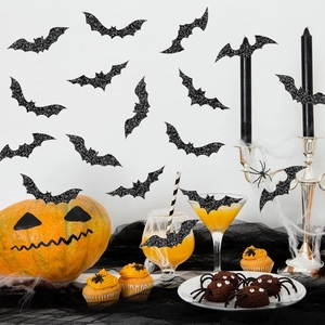 Close-up of holographic bat decorative stickers on a festive Halloween party wall