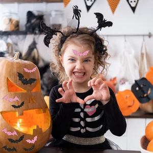 Halloween holographic bat stickers in pink and black glitter applied on skin and decor