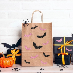 Detail of laser bat stickers on kraft gift bags with Halloween themed festive decorations