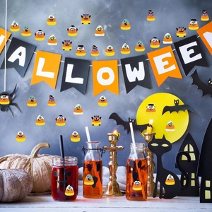 Macro detail of Halloween candy corn stickers showing monster designs on various surfaces