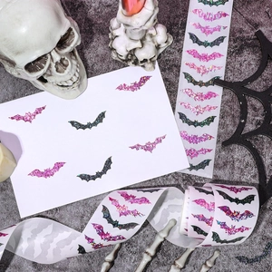 Detail of glitter Halloween bat stickers in black and pink on a textured spooky background
