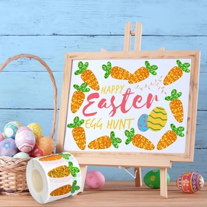 Macro shot of carrot Easter stickers with glitter finish on a light blue wooden background
