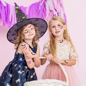 Close-up of Halloween glitter bat stickers applied to facial skin and arms for festive makeup