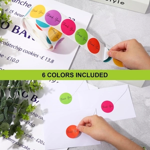 Detailed view of applying colorful round Thank You stickers on a white envelope
