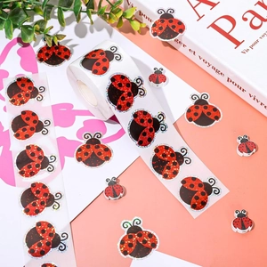 Detail of glitter ladybug stickers and matching 3D decorative elements for DIY crafts