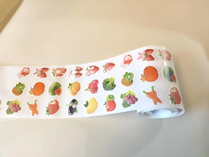 Roll of realistic fruit and vegetable stickers including strawberry and grape patterns