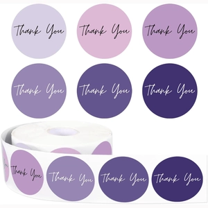 Macro detail of round purple gradient thank you stickers in a 500-label roll format