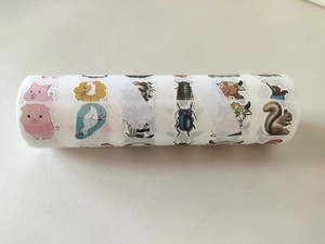 Close-up of animal sticker roll with cute pig, panda and squirrel cartoon patterns