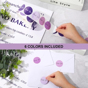 Detail of round purple thank you stickers applied on white envelope for gift sealing