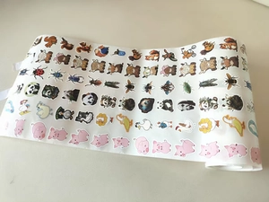 Close-up of decorative roll with various cartoon animal stickers and insects