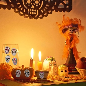 Detail showing Day of the Dead sugar skull stickers applied on glassware and pumpkins