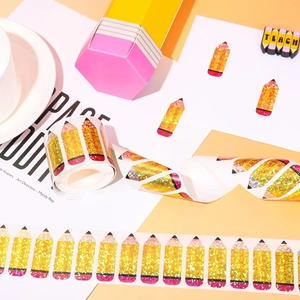 Close-up of glittery pencil stickers with gold finish on a roll for stationery decor