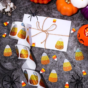 Macro shot of glittery candy corn stickers on a roll for festive Halloween decoration