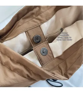 Close-up of canvas tote bag featuring a strong magnetic snap closure and inner zip pocket