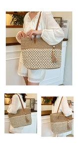 Detail view of large straw tote bag featuring contrast colors and brown leather straps