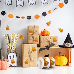 Roll of glittery candy corn stickers on gift boxes for Halloween party decoration