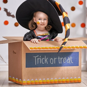 Toddler girl in black witch costume with sequined dress and striped hat for Halloween