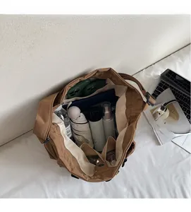 Top view of the spacious inner compartment of this brown canvas tote bag for essentials
