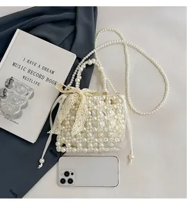 Exquisite pearl-woven mini bag featuring beige lace bow and pearl chain strap details