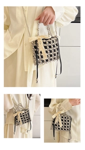 Detail of beaded mini handbag showing hand-woven grid texture and delicate lace bow