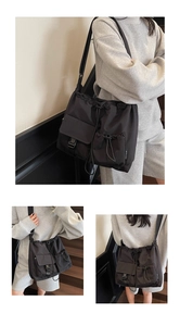 Detail of waterproof nylon shoulder bag with drawstring closure and buckle pocket