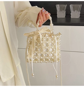 Detail of hand-woven pearl handbag featuring a silk drawstring lining and lace bow