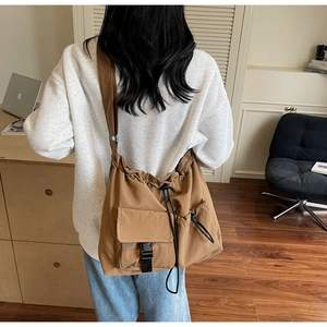 Brown large capacity canvas messenger bag with drawstring and buckle for outdoor use