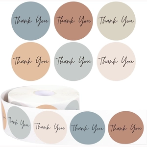 Roll of colorful round thank you labels in morandi tones for gift packaging seal