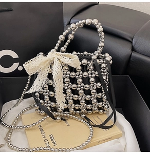 Detail of silver beaded handbag with black satin pouch and delicate lace bow accent