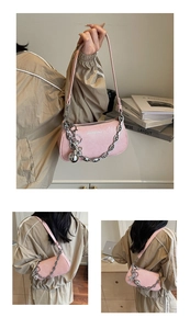 Pink faux leather shoulder bag with chunky silver chain and bear charm detail