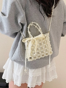 Elegant woven pearl handbag for women with white lace bow and delicate pearl shoulder strap