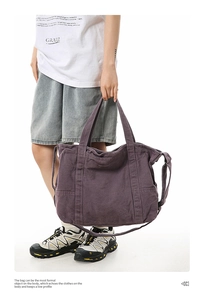 Detail of deep purple canvas tote bag featuring large side pockets and reinforced handles