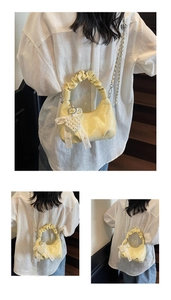 Yellow pleated handle crossbody bag featuring heart pearl charm and lace ribbon detail