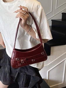 Fashionable dark red patent leather underarm bag with bow decoration and silver buckles