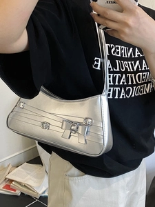 Silver metallic underarm bag with signature bow buckle and glossy PU leather finish