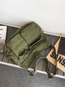 Large military green canvas crossbody bag with two front pockets in retro workwear style