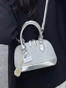 Silver mini shell bag with glittery finish and metallic leather handle for modern style