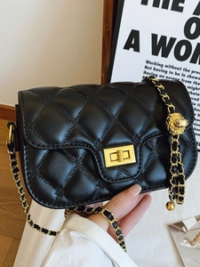 Quilted black shoulder bag with gold chain strap and elegant metallic ball charm