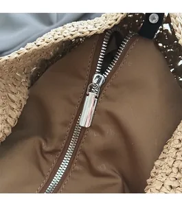 Macro detail of high-quality silver metal zipper and brown fabric lining on woven tote bag
