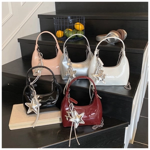 Detailed display of crescent bags in five colors with glossy finish and star charms