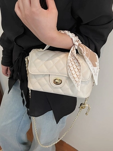 Elegant off-white quilted chain bag with gold twist lock and printed scarf detail