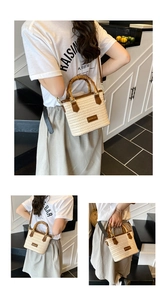 Detail of woven straw bucket bag featuring bamboo handles and adjustable leather straps