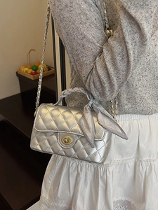Elegant silver quilted crossbody bag with metal chain and silk scarf handle decor