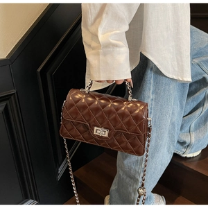 Dark brown quilted chain crossbody bag detail, chic PU leather handbag with metal lock.