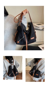 Detail of black nylon tote with brown leather straps and small round coin purse attachment
